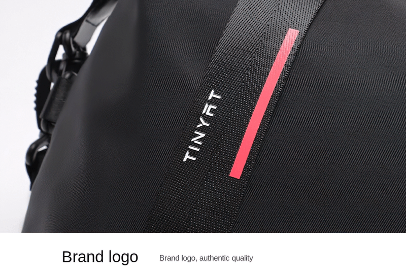 Close-up of black sports shoulder bag with brand logo and red stripe, showcasing durable nylon material and sleek design.