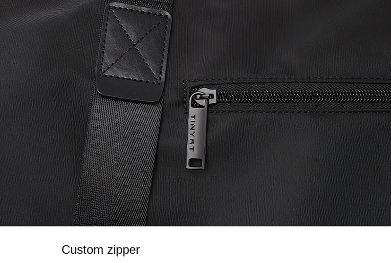 Close-up of a black fashion casual sports shoulder bag with custom zipper detail. Durable nylon fabric and secure stitching visible.