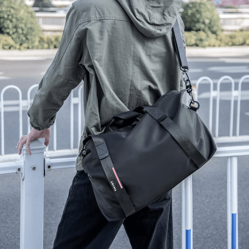 Person wearing fashion casual sports shoulder bag with black nylon design, perfect for lightweight travel and fitness-focused adventures.
