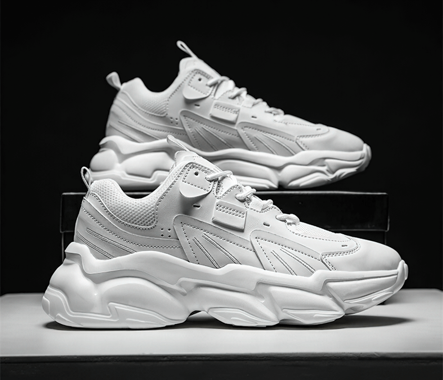 Stylish white lace-up platform male sneakers with breathable mesh design on display.