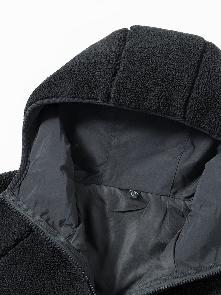 Close-up of black hooded fleece jacket with zipper, featuring a stylish letter embroidery on thick polyester fabric.