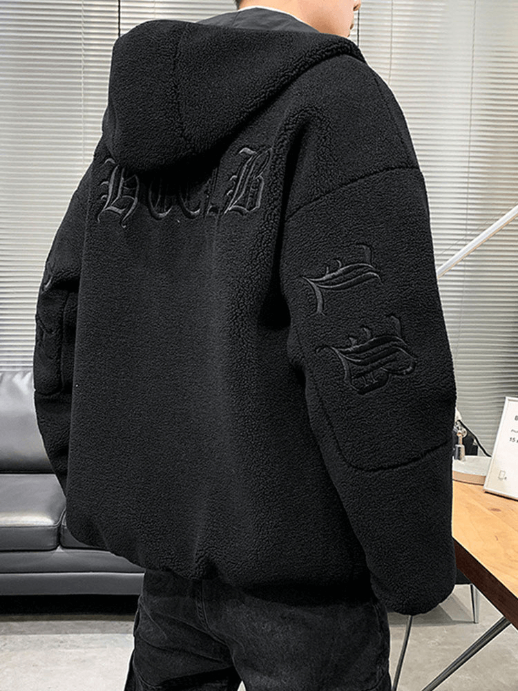 Black hooded fleece jacket with letter embroidery, showing back view in a stylish setting.