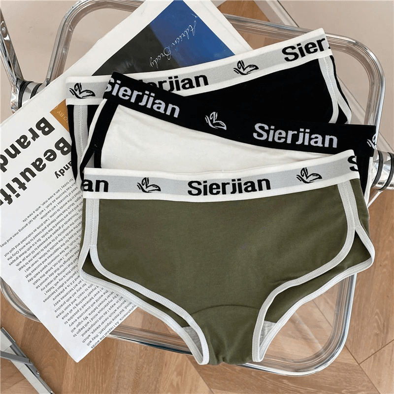 Fashion Letter Print Cotton Sports Briefs in green, black, and white on a chair. Comfortable cotton and spandex blend with stylish design.