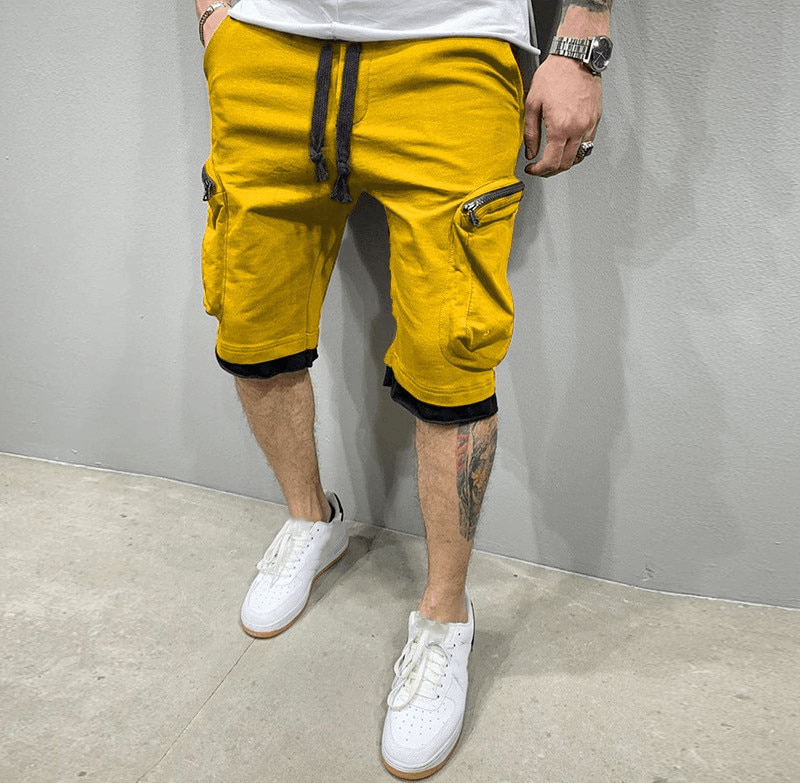 Stylish yellow men's running shorts with zipper pockets and elastic waistband, perfect for comfort and secure storage on the go.