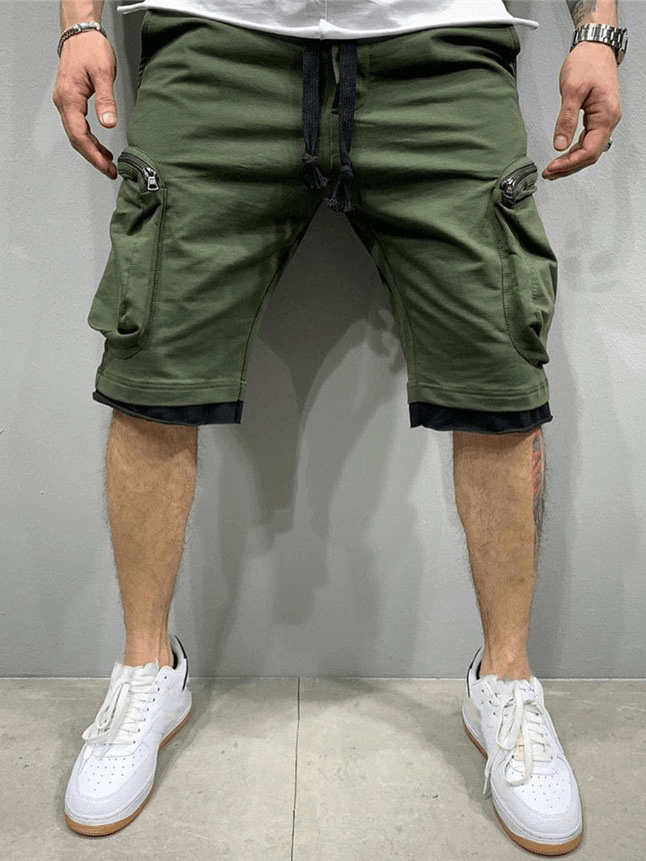 Men's green cotton running shorts with zipper pockets and elastic waistband.