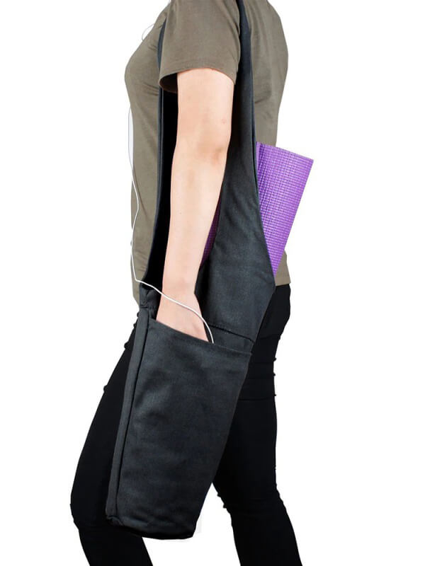 Person carrying fashion one-shoulder yoga bag with purple mat and zippered pocket, perfect for fitness and everyday use.