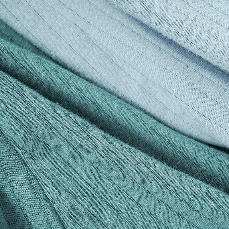Close-up of fashion stripe solid color cotton boxers fabric in soft greens, showcasing elegant stripes and high-quality cotton texture.