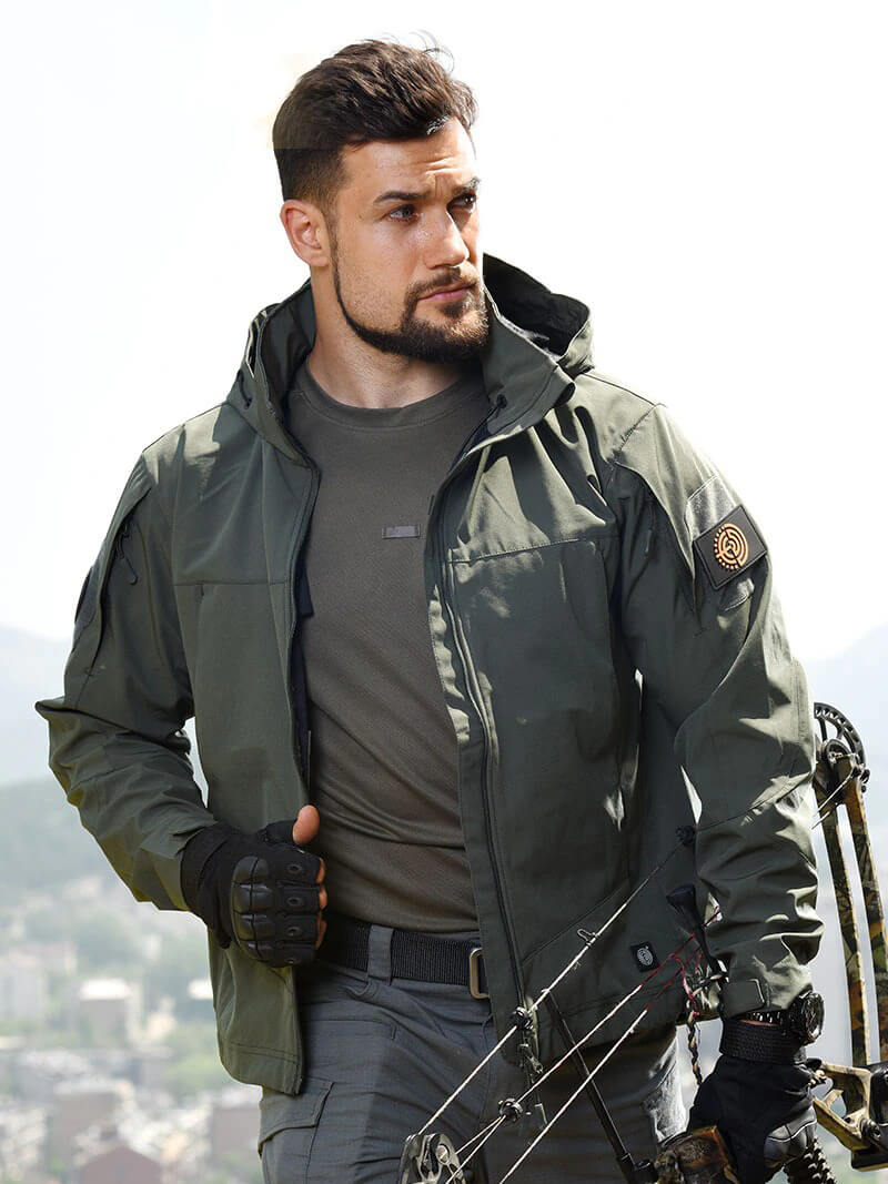 Man wearing a Fashion Tactical Jacket with Hood, ideal for hunting and camping, made from breathable, quick-dry polyester, outdoors with bow.