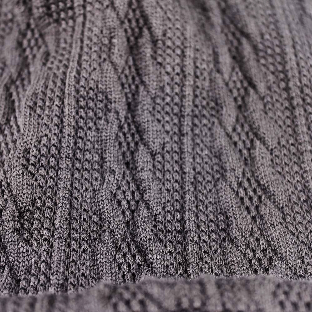 Close-up of a cozy knit fabric texture on a gray beanie, perfect for casual warmth with a stylish pattern.