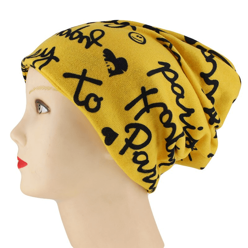Fashion women's letter print warm hat-scarf in yellow with black lettering, providing stylish warmth and comfort. Perfect casual accessory.