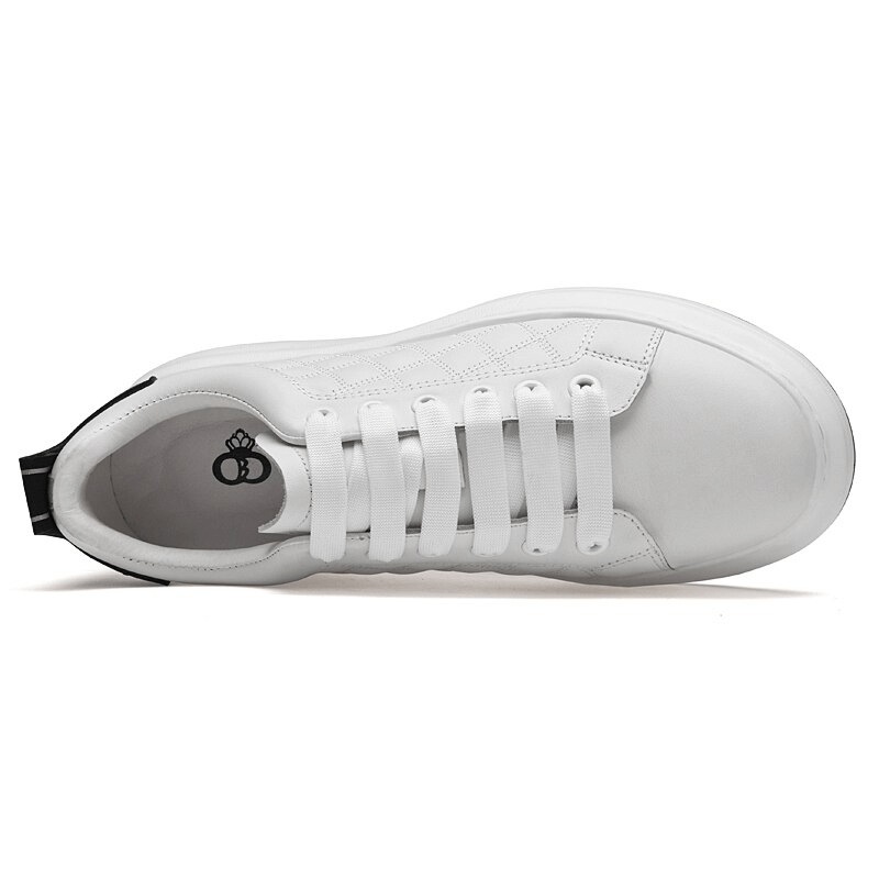 Top view of white fashionable breathable men's sneakers with lace-up design and rubber outsole.