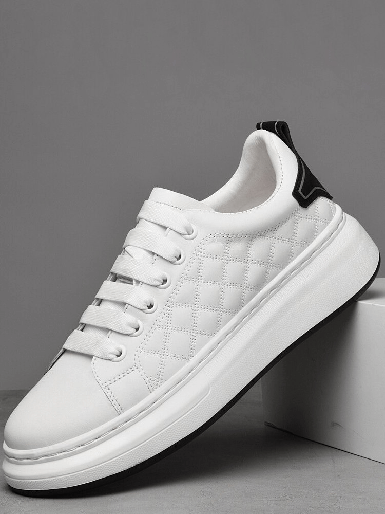 Fashionable breathable casual men's sneaker in white with quilted design and black heel detail, showing lace-up front and rubber sole.