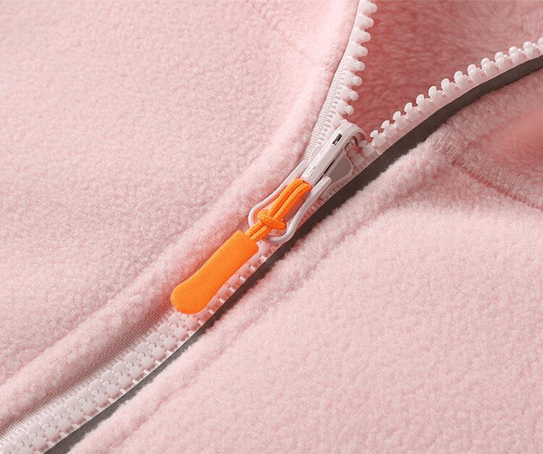 Close-up of pink fleece jacket zipper with an orange pull tab, showcasing the detail and texture of the Fashionable Women's Fleece Jacket.