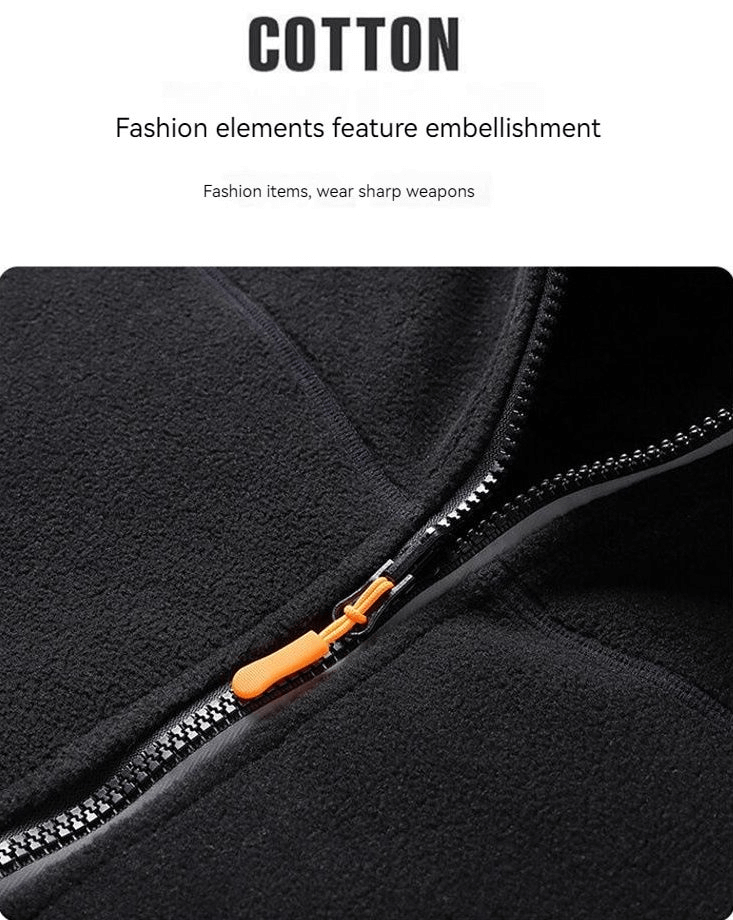 Close-up of zipper on a fashionable double-sided fleece jacket for women, highlighting black fabric and vibrant orange zipper pull.