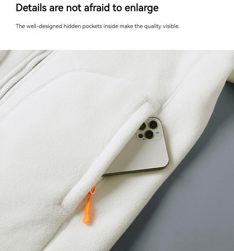 Close-up of fashionable fleece jacket pocket holding a smartphone, showcasing design details and quality stitching.