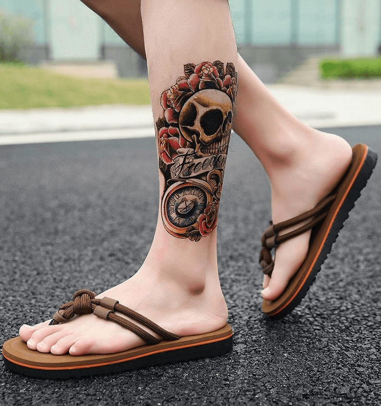 Man wearing stylish lightweight beach flip flops with a detailed leg tattoo, showcasing EVA comfort and durable rubber outsole.