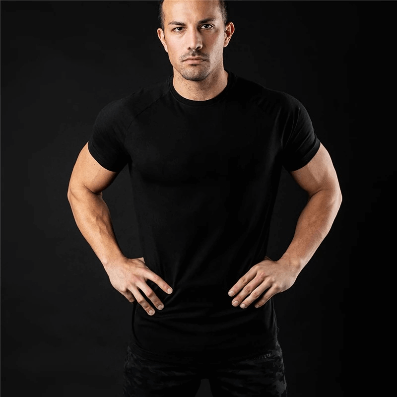 Model wearing a Fashionable Lightweight Sporty Men's T-Shirt for Training, solid black, short-sleeve, O-neck, and breathable design.