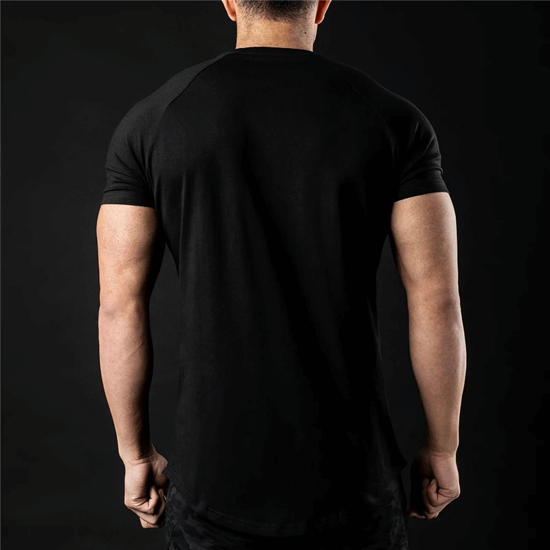 Back view of a man wearing a black lightweight sporty men's t-shirt, perfect for training. Features an O-neck and short sleeves.