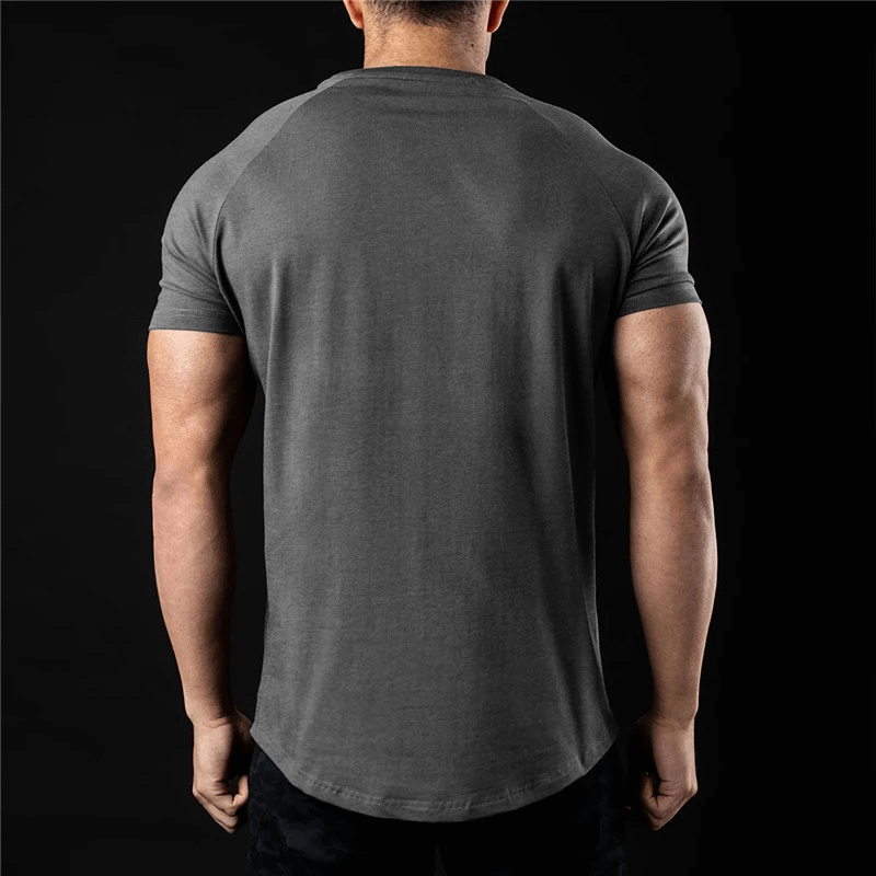 Back view of a fashionable men's lightweight sporty t-shirt, O-neck, short-sleeve, solid color, ideal for training. Model standing.