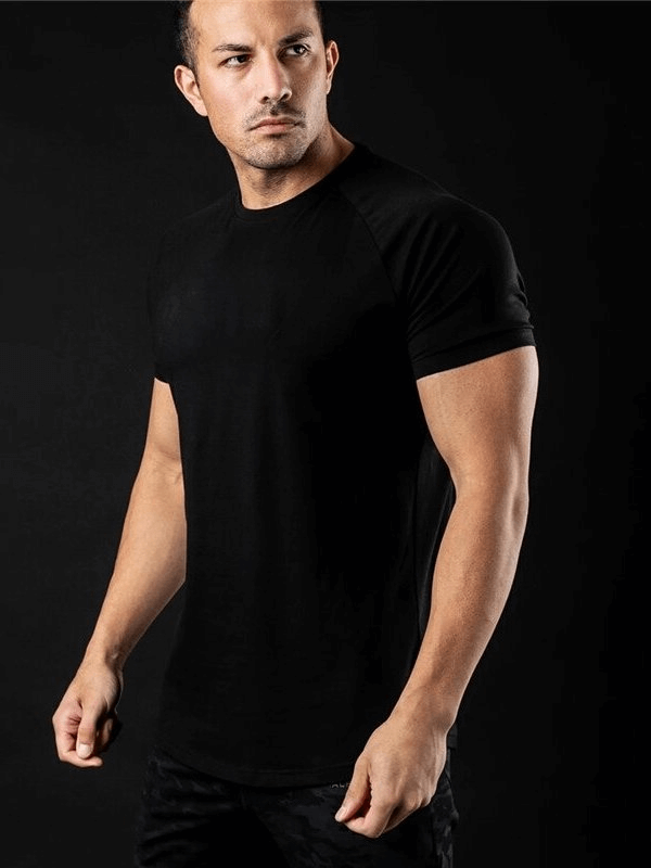 Model wearing a black fashionable lightweight sporty men's T-shirt, ideal for training, featuring a solid-color O-neck and short sleeves.