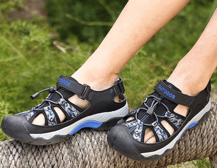 Fashionable non-slip men's open heel sandals with PU upper, EVA insole, and camouflage pattern in an outdoor setting.