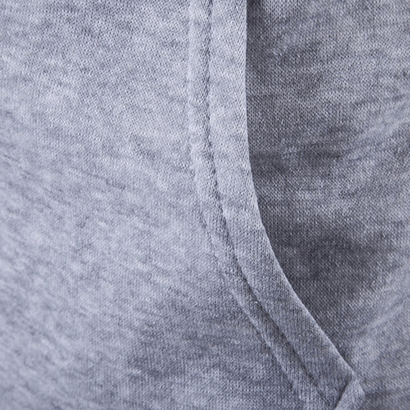 Close-up of grey solid color fabric detail on men's vest with a zipper and hood, showing texture and stitching for a casual style.