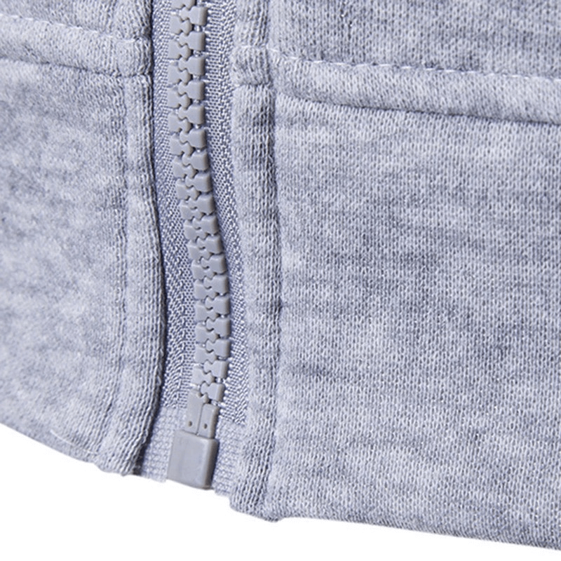 Close-up of gray zipper on men's solid color vest, highlighting cotton-polyester fabric texture.