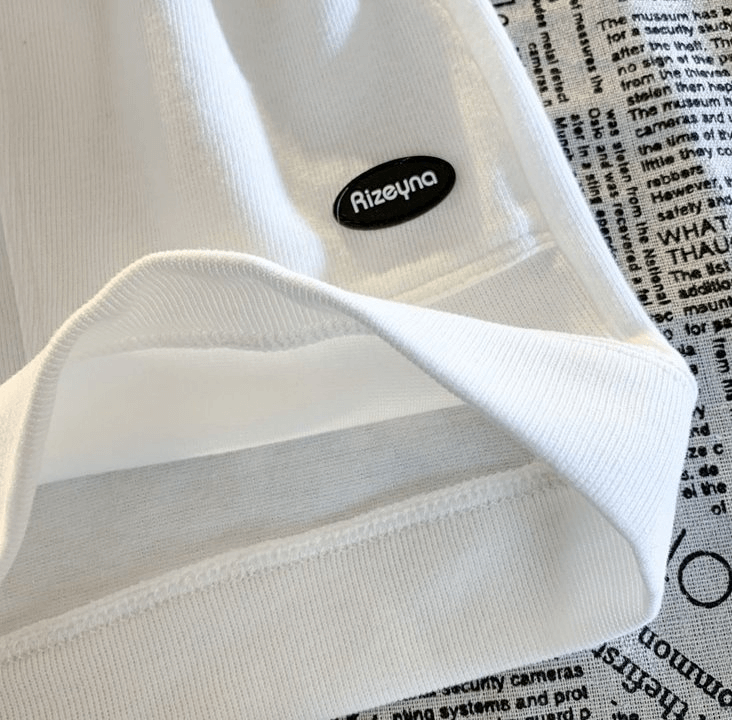 Close-up of fashionable wide women's shorts with large side pockets and a brand label, SF0182, showcasing cotton blend fabric.