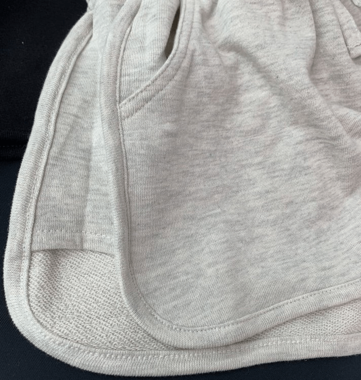 Fashionable women's high-waist loose shorts in light gray with pockets and elastic waistband, perfect for a stylish, comfy look.