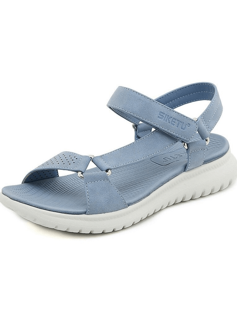 Light blue women's sports platform sandal with adjustable buckle and white sole, offering style and comfort.