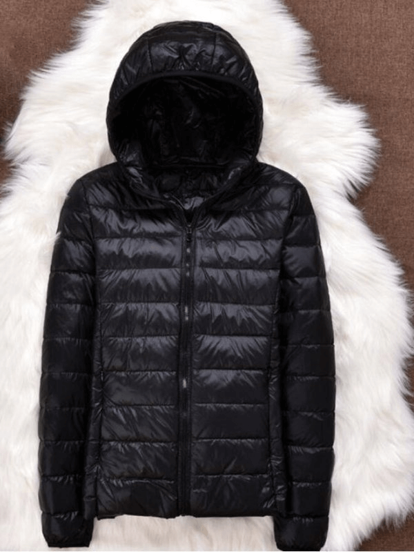 Fashionable women's ultralight hooded jacket in black with premium white duck down filling, shown against a soft fur backdrop.