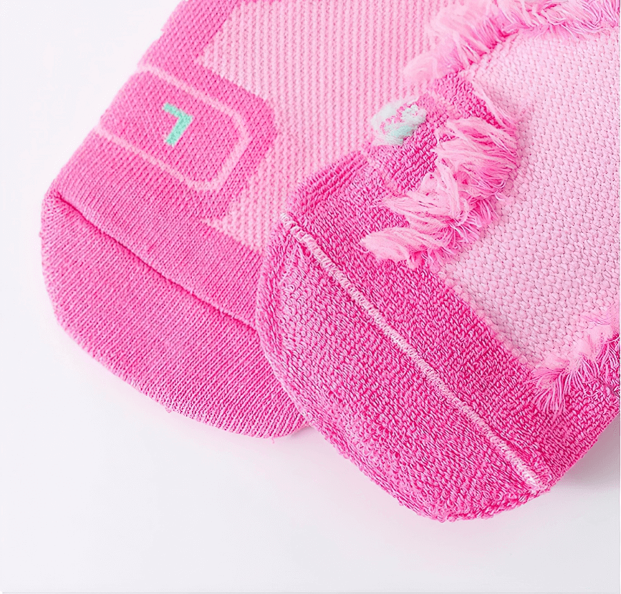 Close-up of vibrant pink basketball knee-high socks highlighting soft, breathable texture.