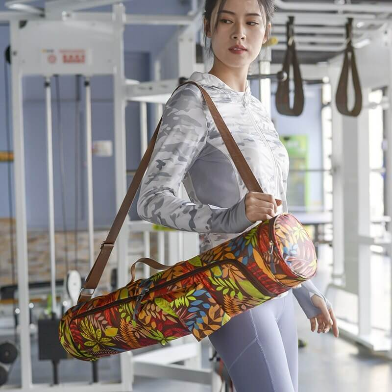 Woman at gym with colorful yoga bag, featuring female print, microfiber material, perfect for pilates and yoga mats, SF0516 design.