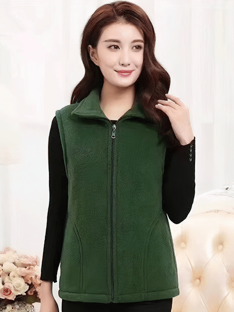 Woman wearing a green fleece vest with zipper and pockets, perfect for warmth and style.