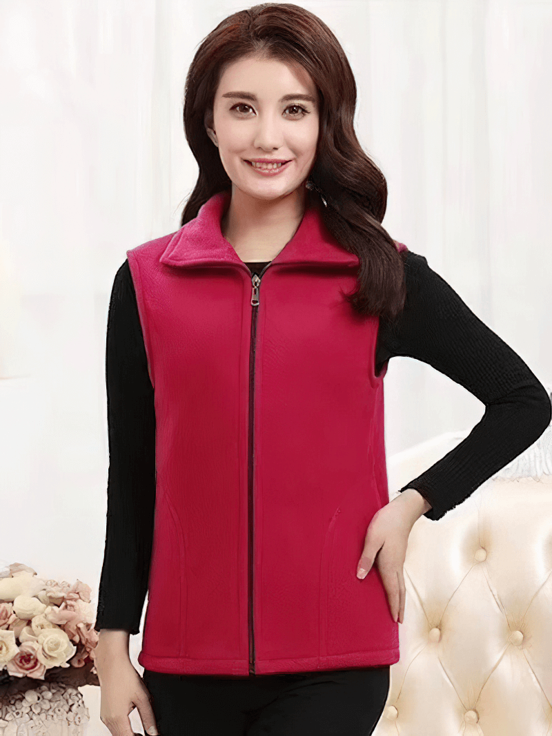 Woman wearing red fleece vest with zipper and pockets, perfect for warmth and style.