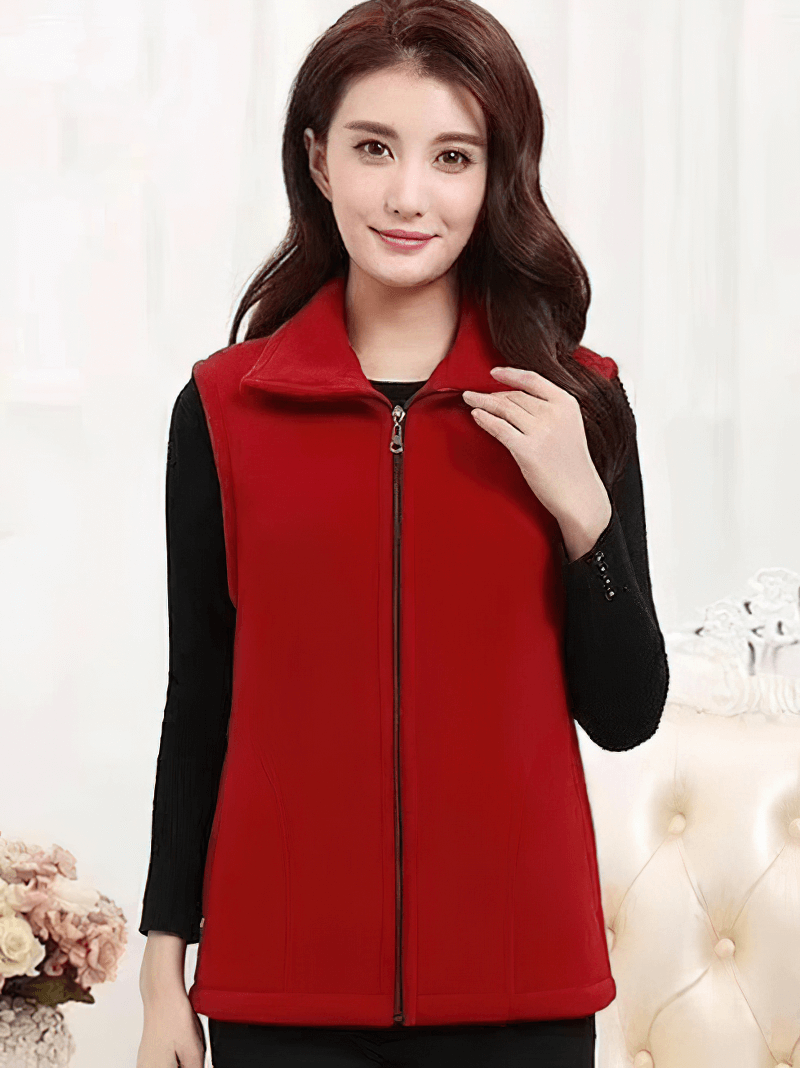 Woman wearing a red fleece vest with zipper and pockets, perfect for warmth and style.