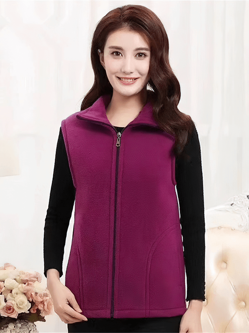 Woman wearing a vibrant purple fleece vest with zipper, showcasing warmth and style for women's clothing. Perfect for cozy occasions.