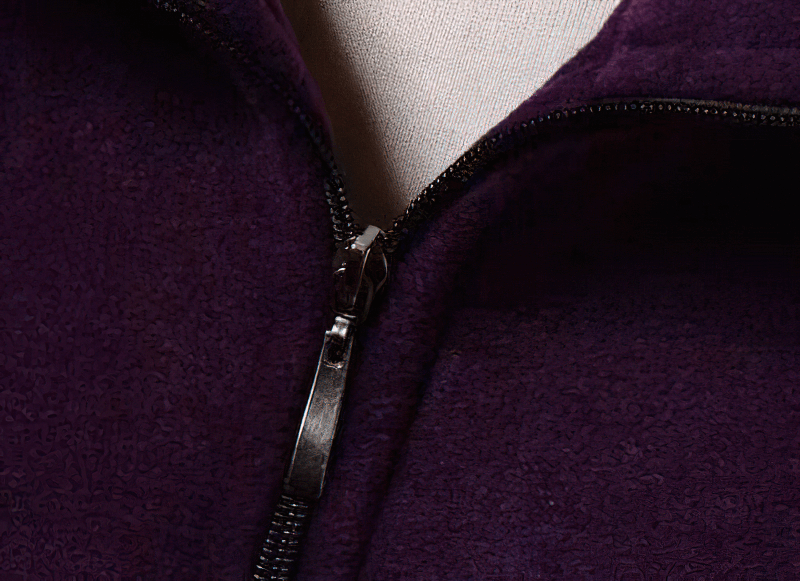 Close-up of a purple fleece women's vest highlighting the zipper detail and warm texture.