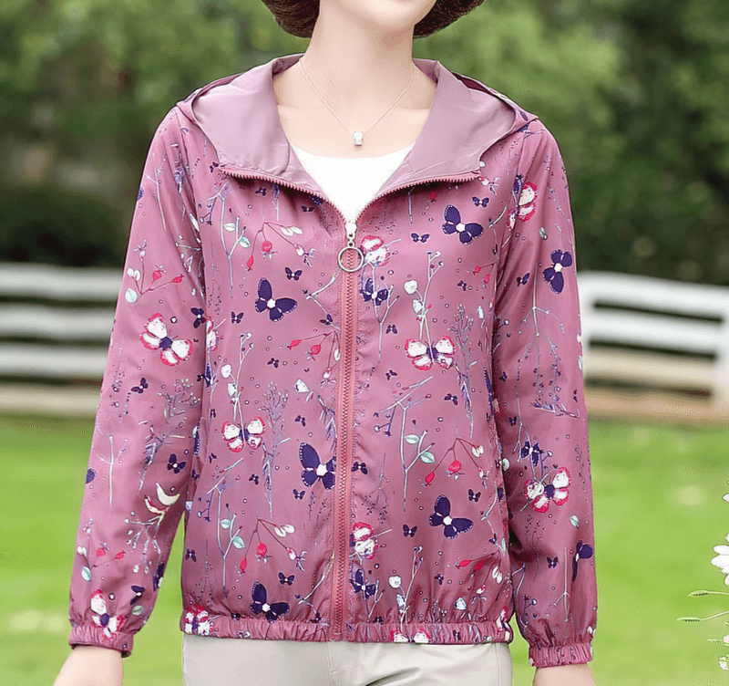 Female zipper hooded reversible windbreaker with floral print, showcasing casual style and convenience for outdoor activities.