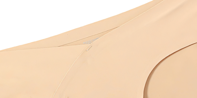 Close-up of seamless solid color briefs in beige, showcasing smooth fabric detail for comfort and style. Suitable for fitness and daily wear.