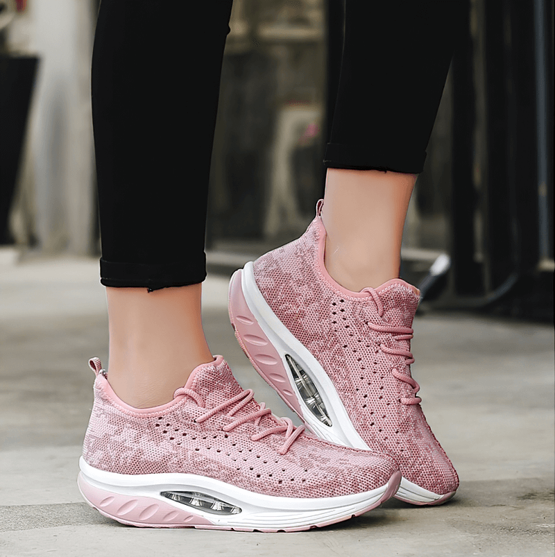 Pink lace-up platform sports sneakers for women, breathable mesh upper, perfect for fitness, shown on a concrete surface.
