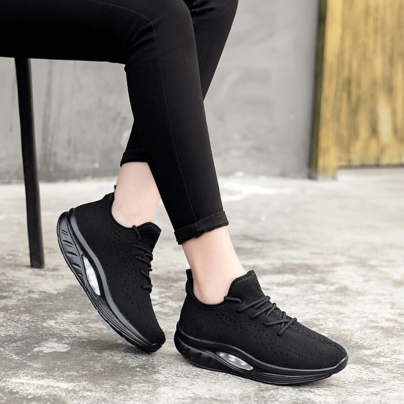 Black lace-up platform sneakers for women, featuring breathable mesh and supportive design, perfect for fitness and everyday wear.