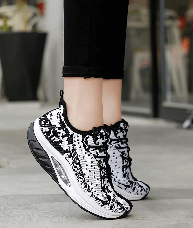 Stylish black and white women's platform sports sneakers with lace-up design, perfect for fitness and everyday wear.