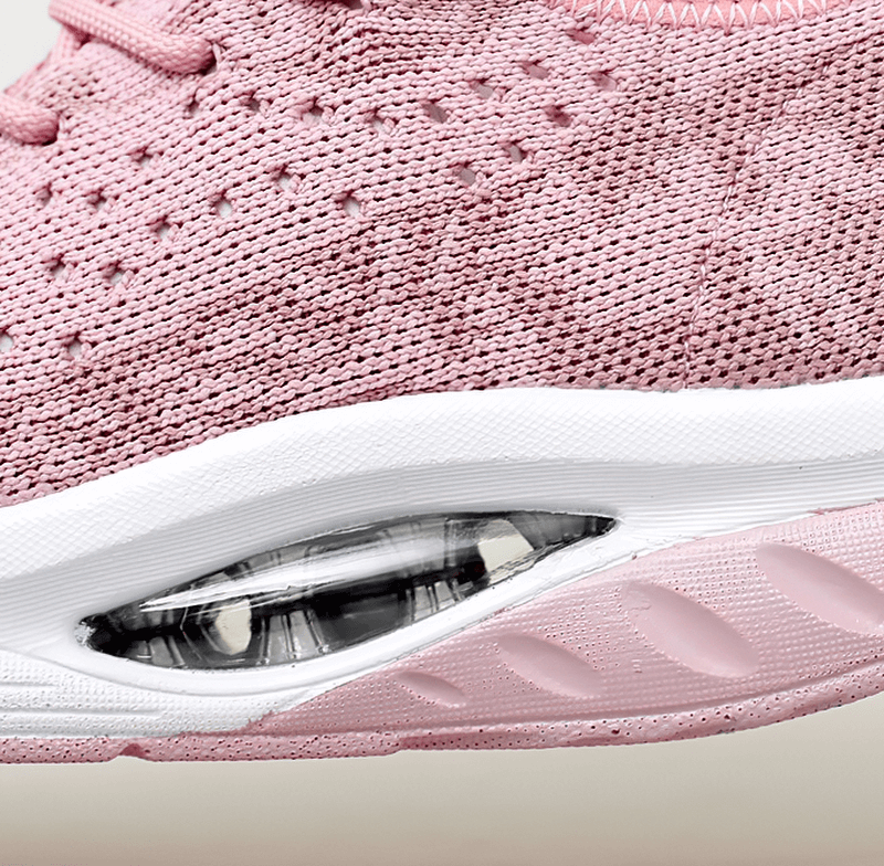 Close-up of pink lace-up platform sports sneaker with breathable mesh and cushioned sole, ideal for women's fitness and performance