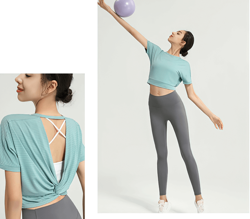 Woman modeling a backless sexy crop top in teal, paired with gray leggings, showcasing activewear for yoga or running. SF0017