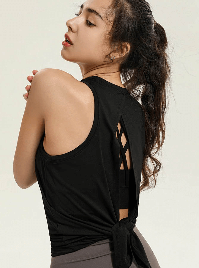 Woman modeling a black fitness tank top with a stylish slit back, ideal for yoga and gym workouts, breathable and quick-drying.