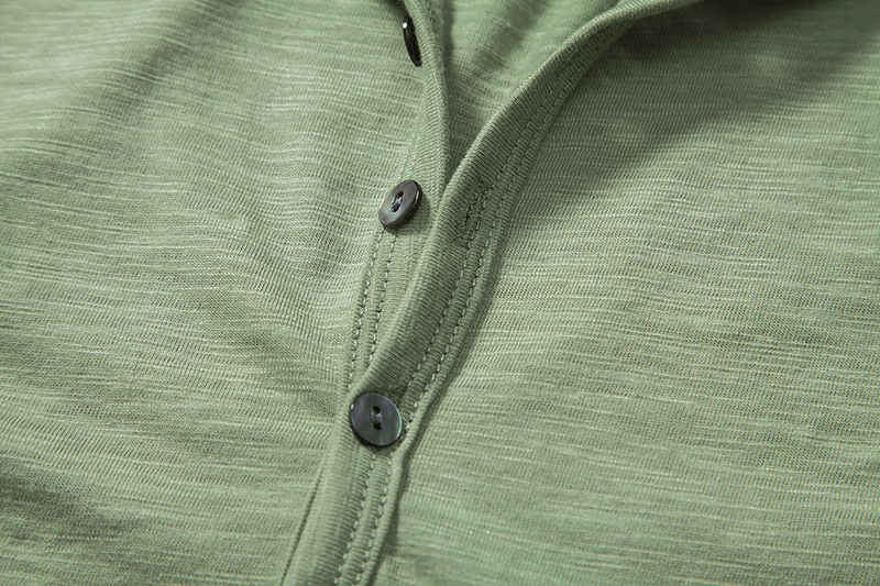 Close-up of green sleeveless hoodie with O-neck and buttons, perfect for men's fitness and workouts.