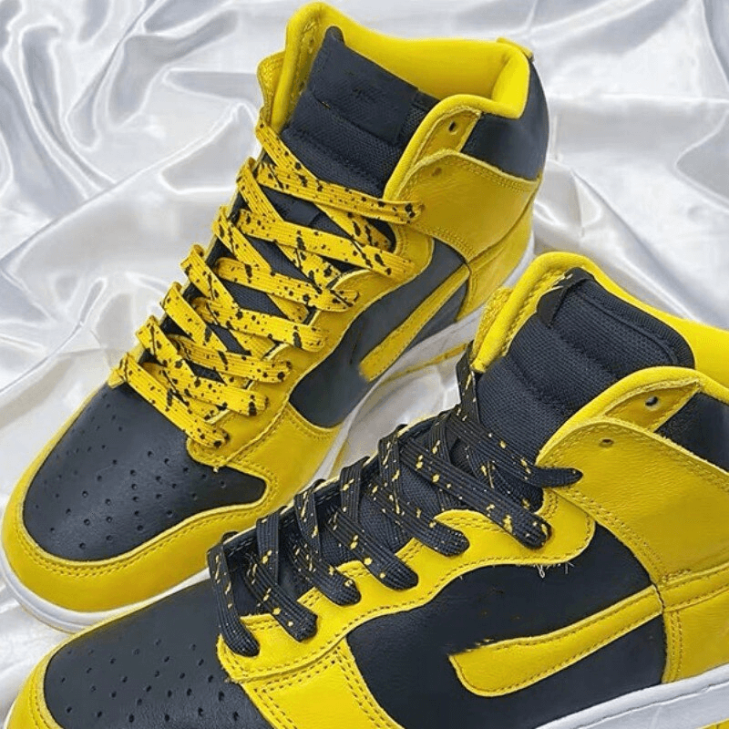 Stylish black and yellow sneakers with durable flat colorful shoelaces, perfect for sports enthusiasts seeking vibrant and long-lasting style.