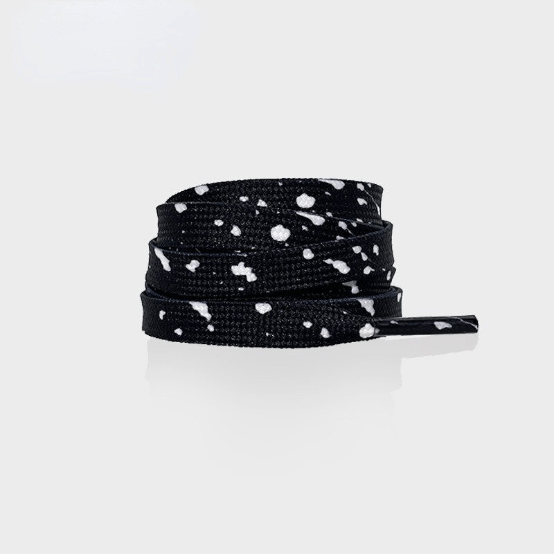 Black shoelaces with white speckles for sports shoes, showcasing a flat durable polyester design for a secure unisex fit.