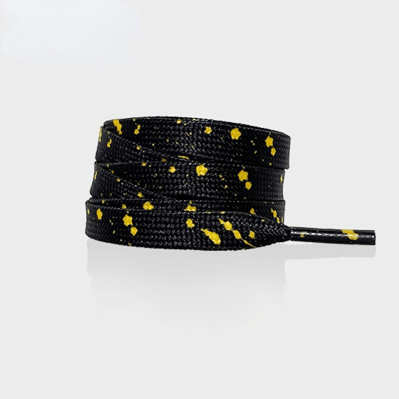 Flat black shoelaces with vibrant yellow speckles, perfect for sports shoes, made of durable polyester. Unisex and stylish accessory.